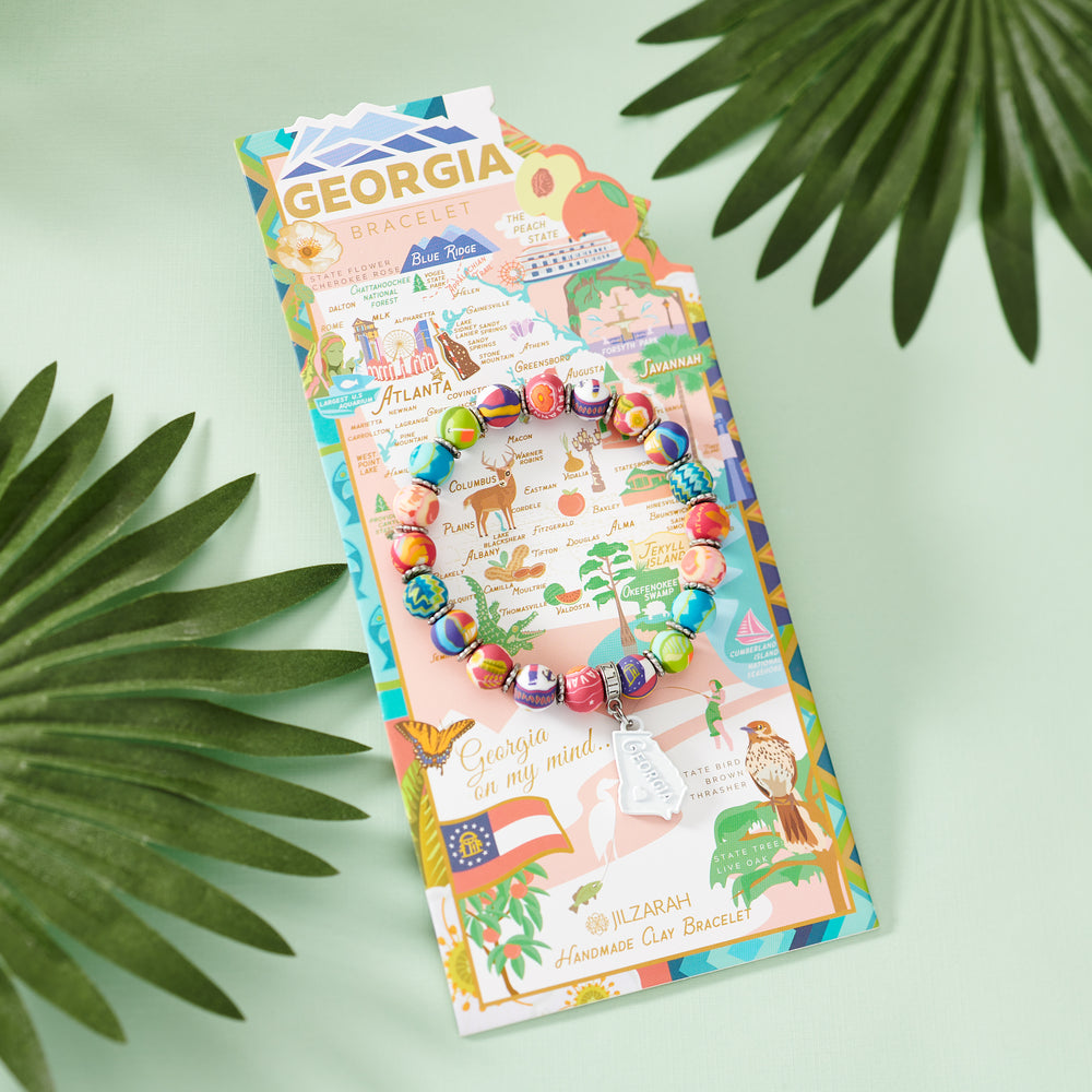 Georgia Places We Love bracelet on its illustrated card among palm leaves